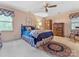 Bedroom with blue bedding, wood dresser, ceiling fan, and carpeted floors at 6614 Alexander Hall Dr, Charlotte, NC 28270