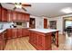 Kitchen boasts wood cabinets, marble countertops, and an island at 12708 Hamilton Rd, Charlotte, NC 28273