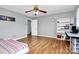Bedroom featuring hardwood floors, ceiling fan, and built-in shelving at 12708 Hamilton Rd, Charlotte, NC 28273