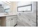 Bathroom boasts a vanity with marble countertop and updated fixtures at 12708 Hamilton Rd, Charlotte, NC 28273