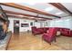 Living room with hardwood floors, exposed beams, and a stone fireplace at 12708 Hamilton Rd, Charlotte, NC 28273