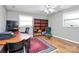 Home office features wood floors, built-in shelving, and a comfortable chair at 12708 Hamilton Rd, Charlotte, NC 28273