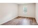 Simple bedroom with hardwood floors and a window with blinds at 804 Sowell St, Lancaster, SC 29720