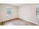 Spacious bedroom with wood-look flooring and two windows with blinds at 804 Sowell St, Lancaster, SC 29720
