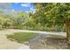 Landscaped yard with trees and a partially visible gravel driveway at 804 Sowell St, Lancaster, SC 29720
