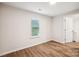 Simple bedroom with wood-look flooring and a window with blinds at 804 Sowell St, Lancaster, SC 29720