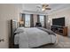 Spacious primary bedroom with large windows and TV at 10193 Meeting House Nw Dr, Huntersville, NC 28078