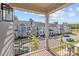 View from balcony showing charming homes and tree-lined street at 10193 Meeting House Nw Dr, Huntersville, NC 28078