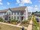 Gray two-story townhome with front porch and landscaping at 10193 Meeting House Nw Dr, Huntersville, NC 28078