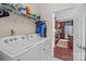 Convenient laundry room with washer, dryer, and shelving at 10193 Meeting House Nw Dr, Huntersville, NC 28078