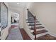 Bright and spacious entryway with staircase and view into living area at 10193 Meeting House Nw Dr, Huntersville, NC 28078