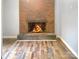 Brick fireplace with a fire burning at 305 N Milford Dr, Salisbury, NC 28144