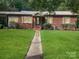 Brick ranch house with a spacious lawn and walkway at 305 N Milford Dr, Salisbury, NC 28144