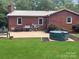 Brick home with a backyard patio, hot tub and grill at 305 N Milford Dr, Salisbury, NC 28144