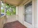 Quaint front porch with wooden flooring and access to the front door at 519 S Mulberry St, Cherryville, NC 28021