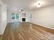 Spacious living room with hardwood floors, fireplace, and large windows at 3903 Planters Watch Dr, Charlotte, NC 28278