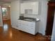 Small kitchen with white cabinets and metal countertop at 2124 W Main St # C, Albemarle, NC 28001