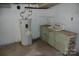 Unfinished basement with water heater and old sink at 2124 W Main St # C, Albemarle, NC 28001