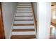 Wooden staircase with white risers and wooden handrail at 2124 W Main St # C, Albemarle, NC 28001