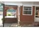 Covered porch with brick flooring and seating area at 2124 W Main St # C, Albemarle, NC 28001