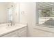 Bright bathroom with white vanity, modern fixtures, and a window with blinds at 1034 Gaston Ave, Gastonia, NC 28052