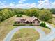 Aerial view of log home on large lot with mature trees at 10510 Hartsell Rd, Midland, NC 28107