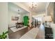Bright entryway with wood floors, green accent cabinet, and view to living room at 540 Kenway Loop, Mooresville, NC 28117