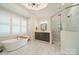 Spa-like bathroom with a soaking tub, walk-in shower, and modern vanity at 540 Kenway Loop, Mooresville, NC 28117