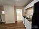 Kitchen with white cabinets, view to living area, and new flooring at 145 33Rd Sw St, Hickory, NC 28602