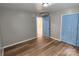 Simple bedroom with light walls, wood-look flooring, and blue doors at 145 33Rd Sw St, Hickory, NC 28602