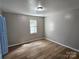 Simple bedroom with light walls, wood-look flooring, and blue doors at 145 33Rd Sw St, Hickory, NC 28602