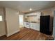 Kitchen with white cabinets, view to living area, and new flooring at 145 33Rd Sw St, Hickory, NC 28602