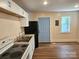 Bright kitchen features white cabinets, new flooring and appliances at 145 33Rd Sw St, Hickory, NC 28602