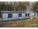 Single-wide mobile home with gray siding and wood steps at 961 Myers Mill Rd, Olin, NC 28660