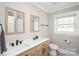 Modern bathroom featuring double vanity, black fixtures, and tiled floor at 1001 E 22Nd St, Kannapolis, NC 28083