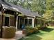 House with a sunroom, brick well, and patio at 701 Whippoorwill Ln, Concord, NC 28025
