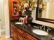 Double vanity bathroom with dark countertops and large mirror at 701 Whippoorwill Ln, Concord, NC 28025
