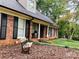 Brick home exterior with black shutters and a manicured lawn at 701 Whippoorwill Ln, Concord, NC 28025