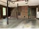 Spacious garage with stairs, brick wall, and ample storage at 701 Whippoorwill Ln, Concord, NC 28025