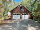 Two-car garage with brick exterior and white doors at 701 Whippoorwill Ln, Concord, NC 28025