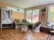 Relaxing sunroom with wicker furniture and tiled flooring at 701 Whippoorwill Ln, Concord, NC 28025