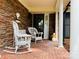 Inviting front porch with rocking chairs and brick flooring at 701 Whippoorwill Ln, Concord, NC 28025