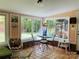 Bright sunroom with large windows, table, and chairs at 701 Whippoorwill Ln, Concord, NC 28025