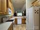 Kitchen with wood cabinets and white appliances at 6261 Alyssum Pl, Denver, NC 28037