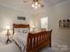 Charming bedroom with a wooden bed frame and en-suite bathroom access at 6261 Alyssum Pl, Denver, NC 28037