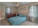 Bedroom featuring a queen bed, dresser, and patterned curtains at 1011 Elm St, Albemarle, NC 28001