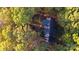 Home with a backyard pond and surrounded by colorful autumn trees at 701 Whippoorwill Ln, Concord, NC 28025