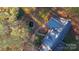 Private backyard with a small pond surrounded by trees in fall colors at 701 Whippoorwill Ln, Concord, NC 28025