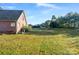 Large backyard with grassy area and playset at 108 Cottonwood Dr, Mount Holly, NC 28120