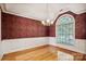 Bright dining room features hardwood floors, crown molding, and a large arched window at 108 Cottonwood Dr, Mount Holly, NC 28120